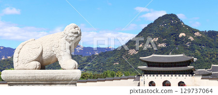 Horizontal banner with statue of mythical creature at Gwanghwamun Gate. View of Gyeongbokgung palace and Inwangsan Mountain, Seoul, South Korea. Topic of summer vacation, travel, cruises and tours 129737064