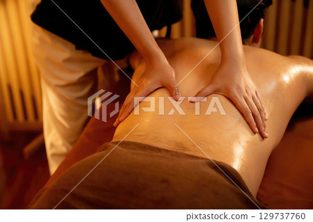 Caucasian man customer enjoying relaxing anti-stress massage. Quiescent 129737760