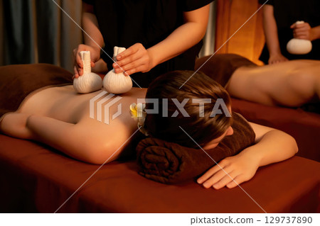 Hot herbal ball spa massage body treatment with couple customer. Quiescent Hot herbal ball spa massage body treatment with couple customer. Quiescent 129737890
