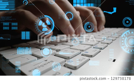Close-up of Hands Typing on a Laptop Keyboard with Futuristic Digital Interface Overlays Representing Technology and Data Analysis Concepts xenic Close-up of Hands Typing on a Laptop Keyboard with Futuristic Digital Interface Overlays Representing Technology and Data Analysis Concepts xenic 129738178