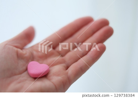 Hands and heart of a woman in her 40s Hands and heart of a woman in her 40s 129738384