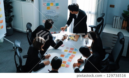 Top view business man put sticky notes on whiteboard at meeting. Directorate. 129738516