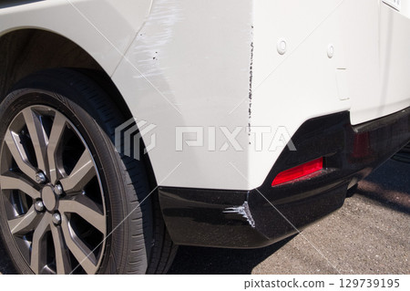 Damaged rear of car, auto repair, scratches 129739195