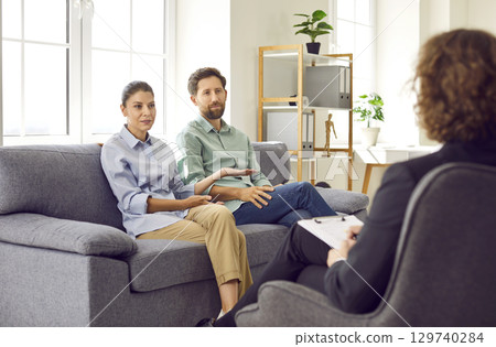 Married couple having a therapy session with a professional therapist or family psychologist Married couple having a therapy session with a professional therapist or family psychologist 129740284