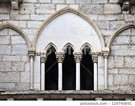 Gothic window detail in Rocamadour, France, showcasing intricate design and historical architecture 129740691
