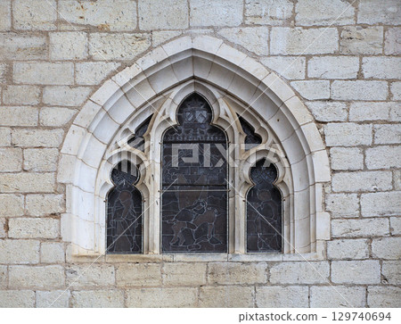 Gothic window detail in Rocamadour, France, showcasing intricate design and historical architecture 129740694