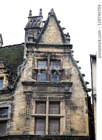 Maison de la Boetie in Sarlat-la-Caneda with intricate stonework and unique rooflines 129740704
