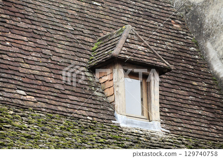 Traditional roof window of a historic building in Sarlat-la-Caneda, France, rustic architecture Traditional roof window of a historic building in Sarlat-la-Caneda, France, rustic architecture 129740758