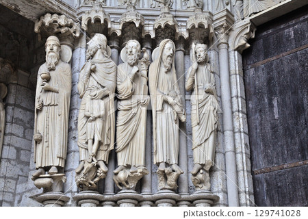 Sculptural details at Notre-Dame de Chartres Cathedral in France showcasing intricate stone carvings Sculptural details at Notre-Dame de Chartres Cathedral in France showcasing intricate stone carvings 129741028