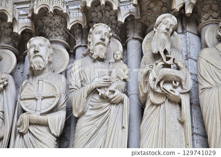 Sculptural details at Notre-Dame de Chartres Cathedral in France showcasing intricate stone carvings Sculptural details at Notre-Dame de Chartres Cathedral in France showcasing intricate stone carvings 129741029