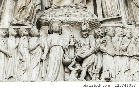 Sculpture of the Day of Judgement adorning Notre Dame Cathedral in Paris, France 129741058