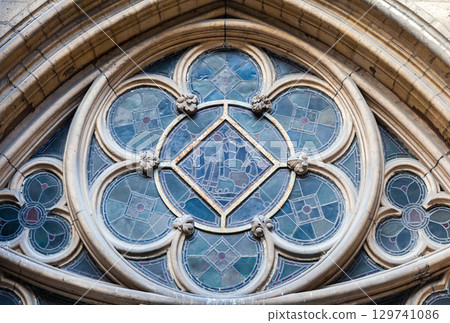 Stained glass window at Sainte-Chapelle showcasing intricate design, exterior Stained glass window at Sainte-Chapelle showcasing intricate design, exterior 129741086