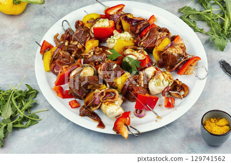 Metal skewers with raw meat. 129741562