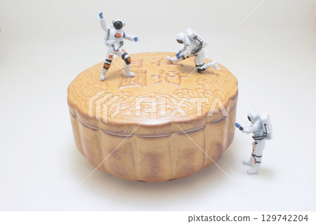 Miniature Astronauts Exploring a Mooncake in Whimsical Conceptual Art 129742204