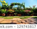 DIY tiles laid on the roof balcony. Plants and blue skies make for a fun day. 129743817