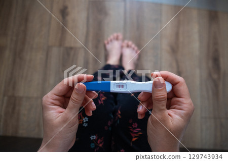 Positive Pregnancy Test in Hand 129743934
