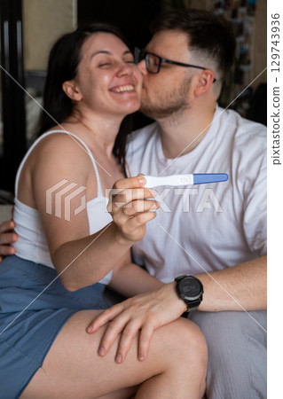 Happy Couple Celebrating Positive Pregnancy Test 129743936