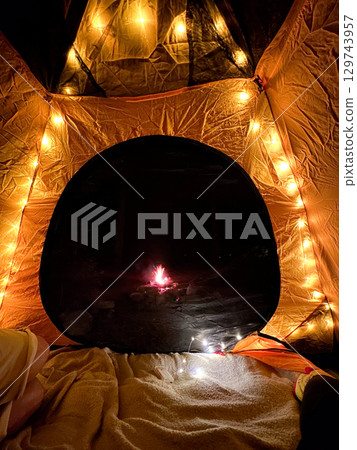 Cozy Tent with String Lights and Campfire View Cozy Tent with String Lights and Campfire View 129743957