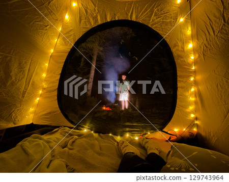 Cozy Tent View with Campfire in Forest Cozy Tent View with Campfire in Forest 129743964
