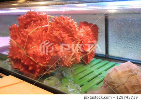 Hanasaki crabs lined up in a display case 129745719