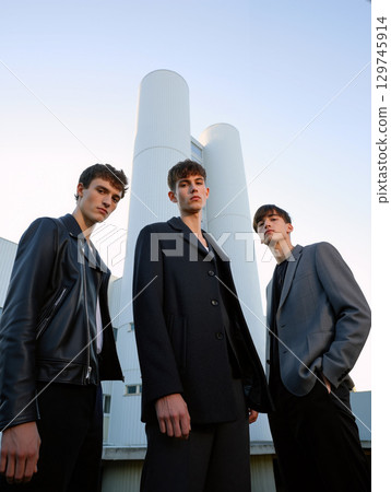 Fashionable Men Posing Confidently in Urban Setting During Sunset Under Clear Sky 129745914