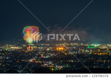 A summer tradition: Fireworks display. Night view of Kumamoto city and the Gozu Lake fireworks display seen from the Aso District viewpoint. A summer tradition: Fireworks display. Night view of Kumamoto city and the Gozu Lake fireworks display seen from the Aso District viewpoint. 129746378