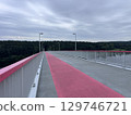 View of the pedestrian bridge leading to Neman River beach and the biggest park in Kaunas city (Lithuania). 129746721