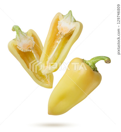 Yellow pepper and two halves flying on a white background. Isolated Yellow pepper and two halves flying on a white background. Isolated 129746809