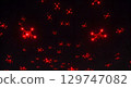 Red glowing drones flying in dark night sky creating futuristic and mysterious atmosphere 129747082