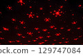 Red drone swarm flying in dark night sky with glowing lights creating futuristic scene 129747084