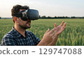 Virtual reality headset man exploring digital world with hands in green field 129747088
