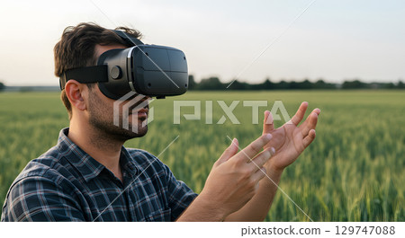 Virtual reality headset man exploring digital world with hands in green field 129747088