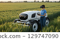 Autonomous agricultural robot green field with person using virtual reality headset for control 129747090