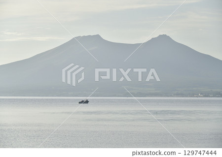 A photo of Mount Sawara and fishing boats taken from Yakumo Town, Hokkaido in summer A photo of Mount Sawara and fishing boats taken from Yakumo Town, Hokkaido in summer 129747444