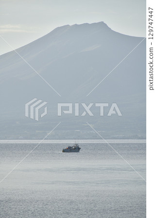 A photo of Mount Sawara and fishing boats taken from Yakumo Town, Hokkaido in summer 129747447