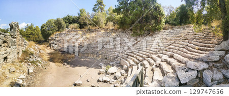 Ancient amphitheater ruins in Phaselis Ancient Cityin Tyrkey. Panorama. Banner. 129747656