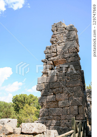Ancient stone tower ruins in Phaselis Ancient City, Turkey 129747669