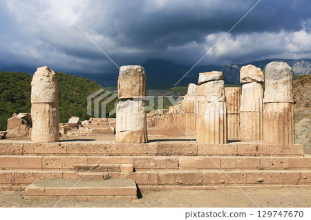 Travel in Turkey. Antique ruins of Phaselis Ancient City with dramatic sky backdrop Travel in Turkey. Antique ruins of Phaselis Ancient City with dramatic sky backdrop 129747670