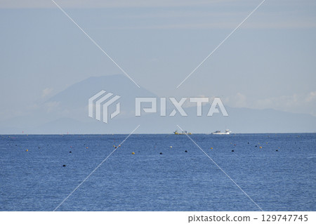 Photographing the scenery of Mt. Yotei and fishing boats on the opposite shore in Yakumo Town, Hokkaido in summer Photographing the scenery of Mt. Yotei and fishing boats on the opposite shore in Yakumo Town, Hokkaido in summer 129747745