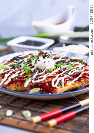 Okonomiyaki - traditional Japanese dish. Okonomiyaki - traditional Japanese dish. 129748053