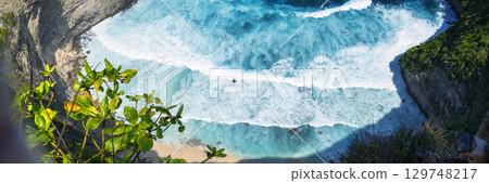 Banner Turquoise ocean sea water white wave pattern splashing deep blue sea. Banner Tropical sea beach Seascape dark background wave splash on rock. Summer Ocean Surface big wave with copy space 129748217
