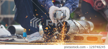 Banner Men hands wear protective glove Hot flame metal work cut fire iron workshop. Locksmith cut metal process. Construction Worker hands using Welding machinery iron metal sparking with copy space 129748245