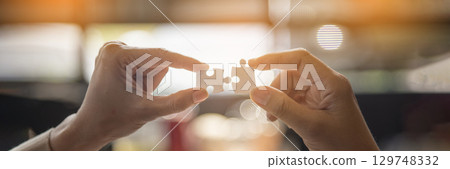 Banner Implement puzzle improve hand holding together solve synergy organize team connection plan trust strategy. Stakeholder business trust teams hands holding jigsaw puzzle synergy with copy space 129748332