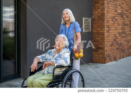 Home caregiver assisting older woman during grocery run Home caregiver assisting older woman during grocery run 129750705