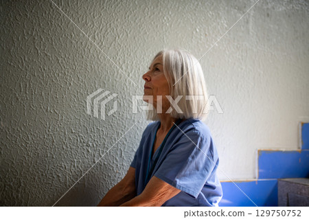 Exhausted nurse resting on stairwell during hospital shift 129750752