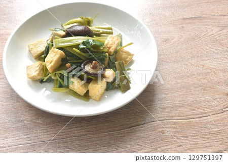 fried slice morning glory with tofu topping black mushroom in soy sauce on plate 129751397