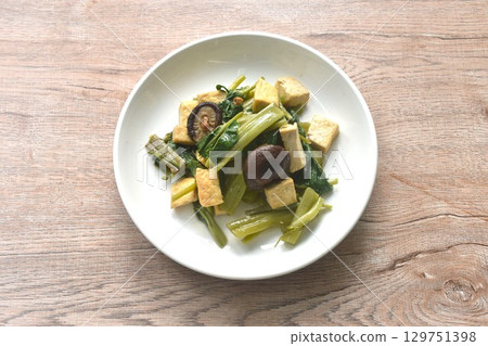 fried slice morning glory with tofu topping black mushroom in soy sauce on plate 129751398