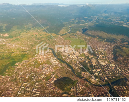 Aerial view of expanding cityscape blending into farmland. Urban growth, land division, and transition between natural and built environments. Aerial view of expanding cityscape blending into farmland. Urban growth, land division, and transition between natural and built environments. 129751462