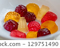 Assorted fruit jelly candies in various shapes and colors are displayed in close-up shot. The image captures the vibrant colors and textures of deliciously sweet treats 129751490