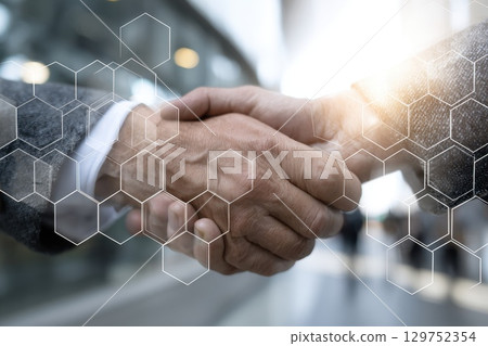 Close-Up Handshake Moment with Blurred Background and Reflection in Business Environment Close-Up Handshake Moment with Blurred Background and Reflection in Business Environment 129752354